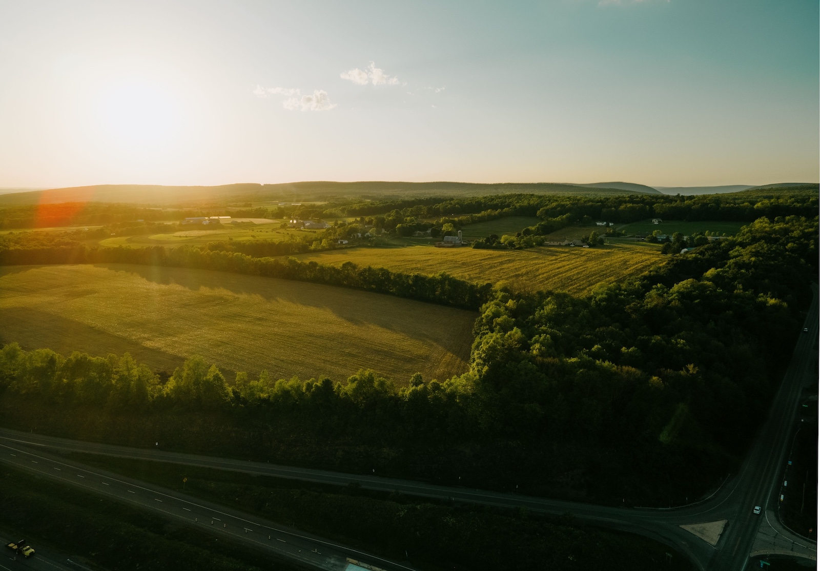 The,Beautiful,Drone,Landscape,Over,Lush,Farm,Fields,And,Highways The beautiful drone landscape over lush farm fields and highways under sunset sky in Pennsylvania