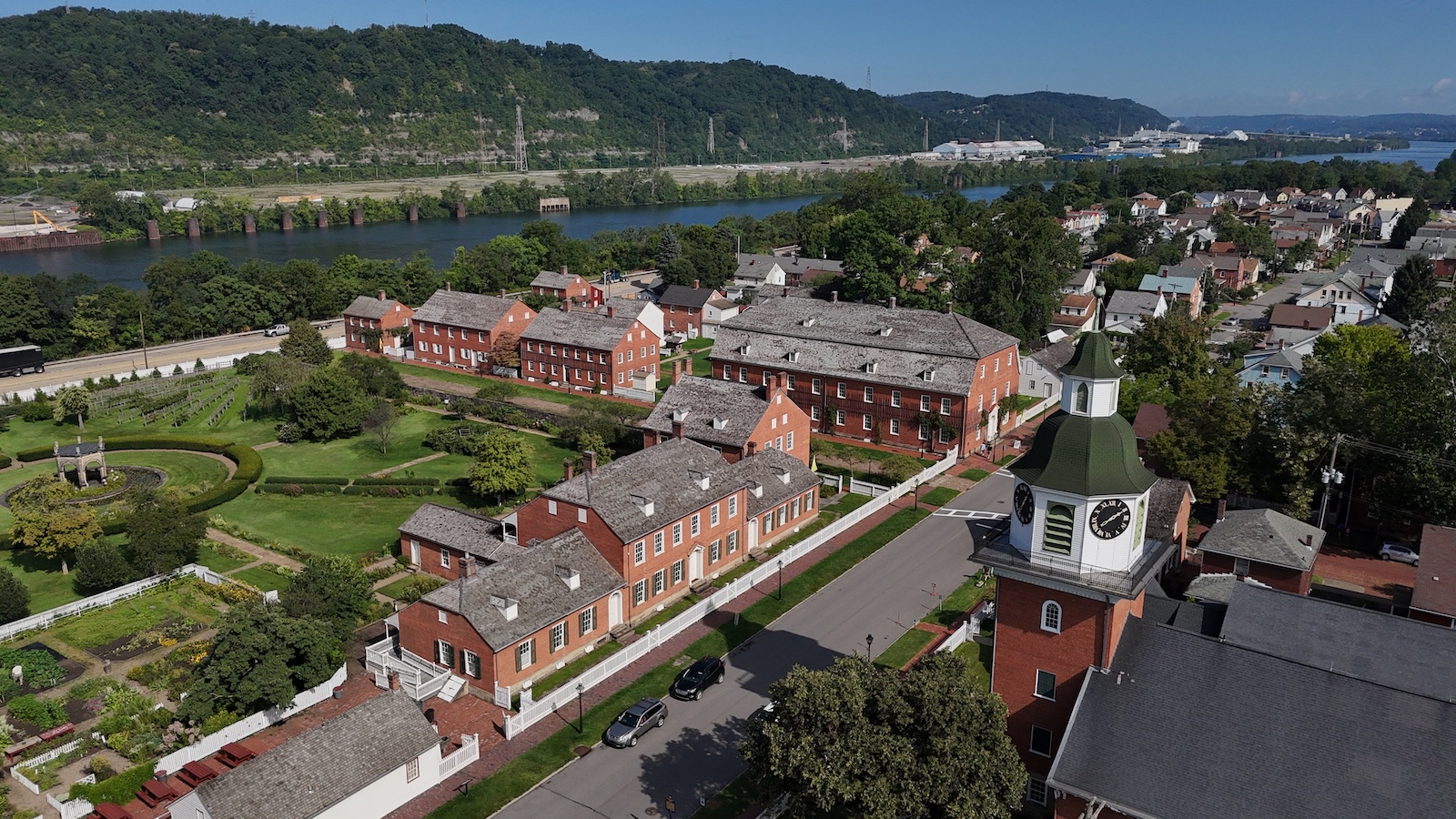An aerial establishing shot of the small Pennsylvania town of Ambridge, Beaver County. Ohio River in the distance, small church in the foreground. Pittsburgh suburbs.